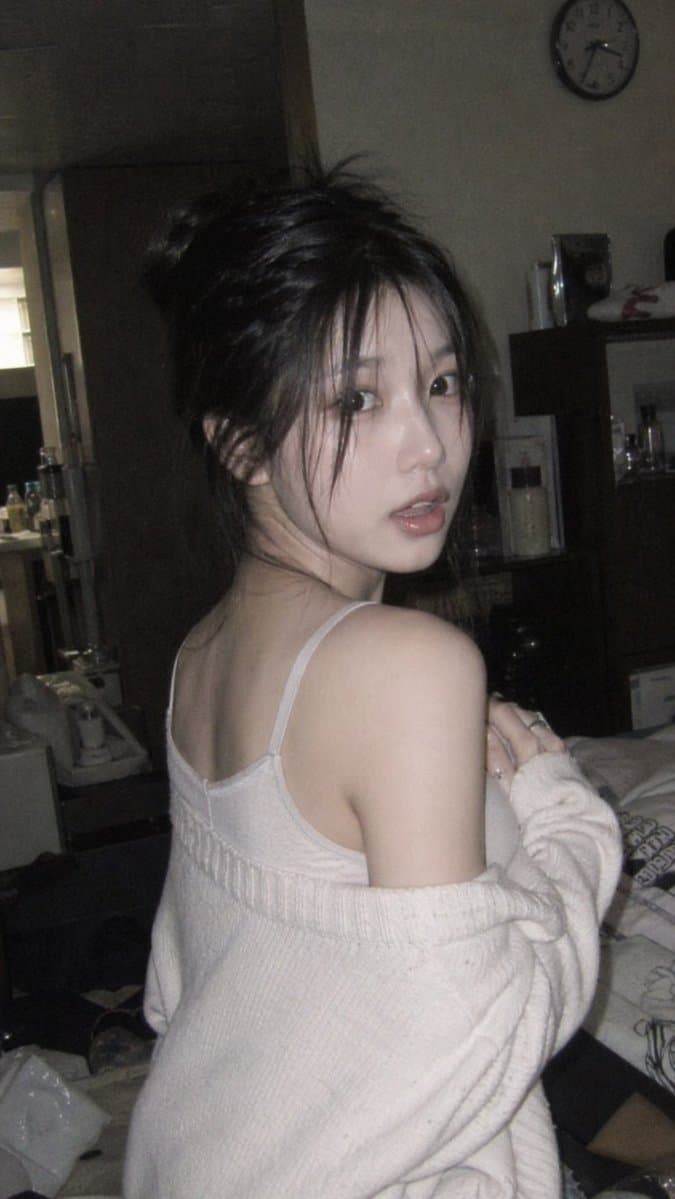 The Unexpected Glance of an Innocent Girl in Dim Indoor Light